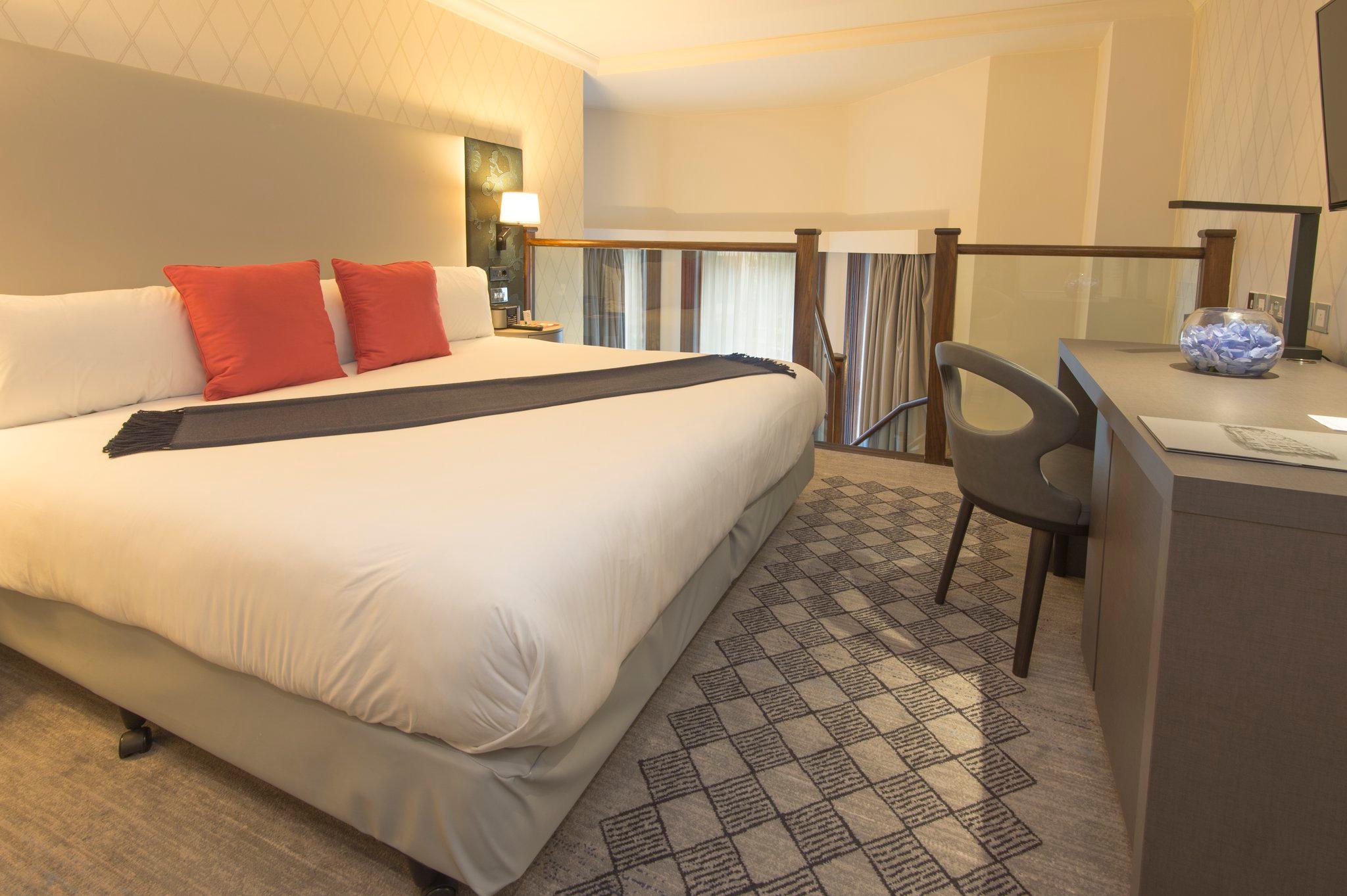 A bedroom with a large bed in a hotel room