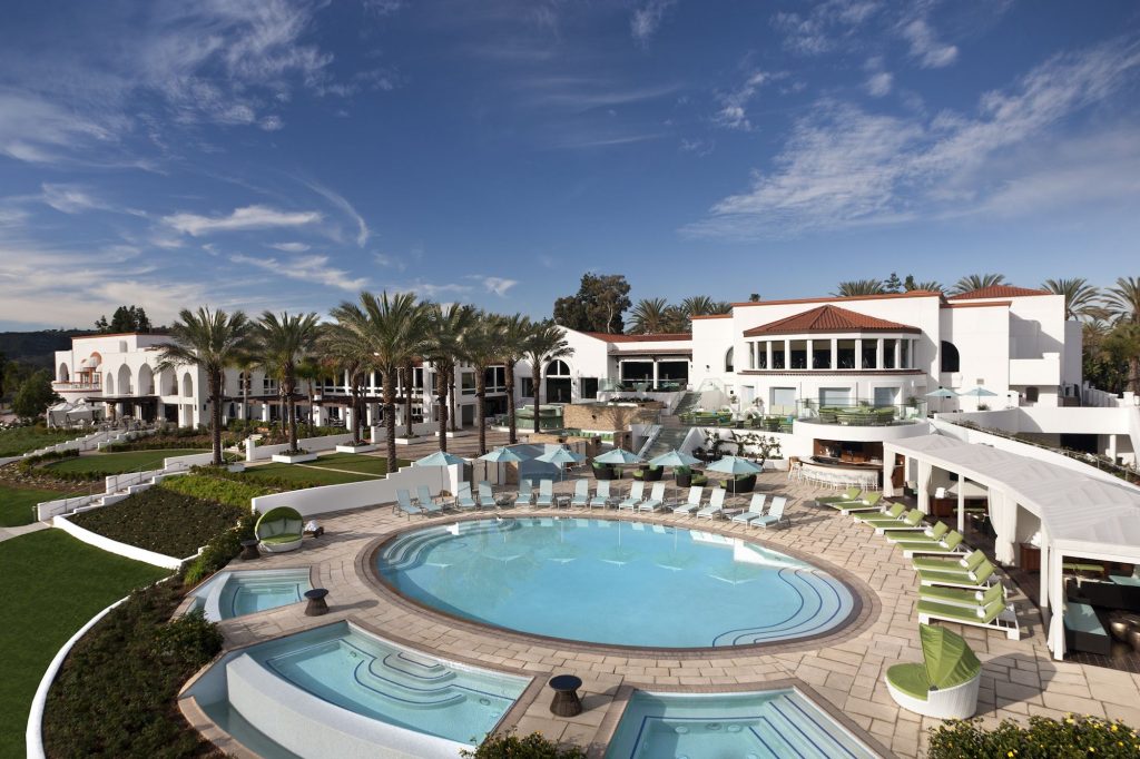 A house with a pool in front of a building