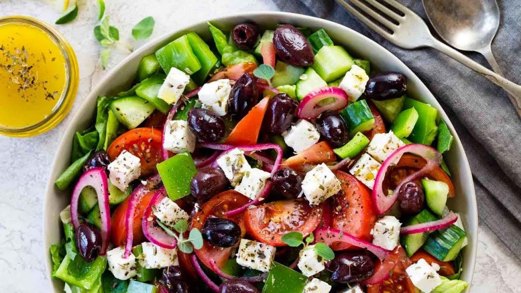 A bowl of fruit and vegetable salad on a plate