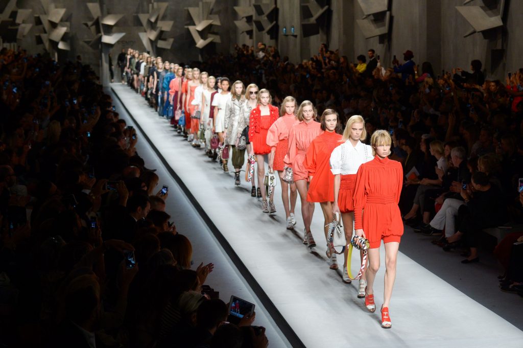 A group of people standing in front of a crowd